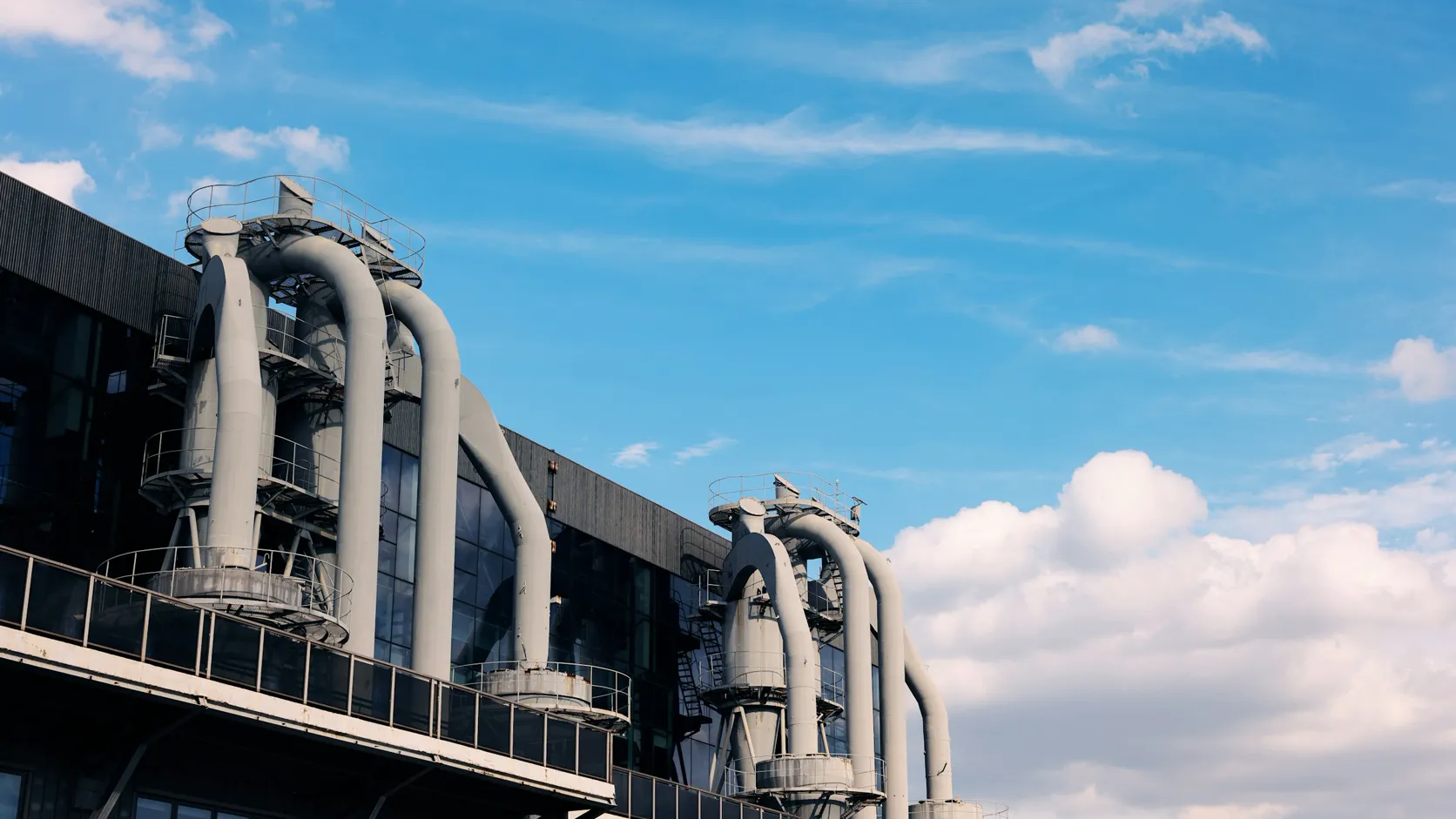 Industrial process manufacturing plant with large pipes and equipment.