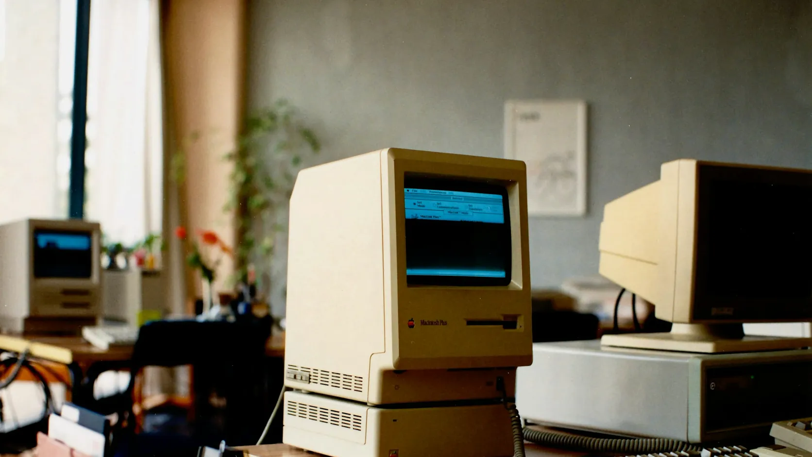 Vintage desktop computers in an office, representing legacy desktop feed formulation software.